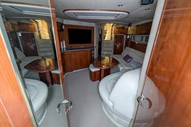 Tigress Yacht Photos Pics Luxurious interior of 2002 Sea Ray 550 Sundancer yacht with plush seating and entertainment area.