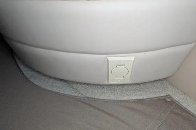 Tigress Yacht Photos Pics Power outlet on Sea Ray 550 Sundancer 2002 boat interior, beige upholstery.