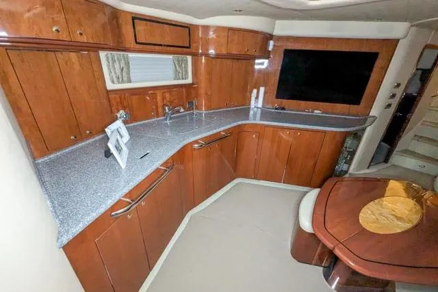 Tigress Yacht Photos Pics Luxurious 2002 Sea Ray 550 Sundancer yacht interior with modern kitchen and dining area.