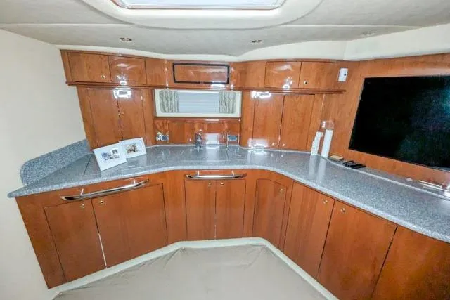 Tigress Yacht Photos Pics Luxurious 2002 Sea Ray 550 Sundancer yacht interior with sleek wooden cabinetry and modern amenities.