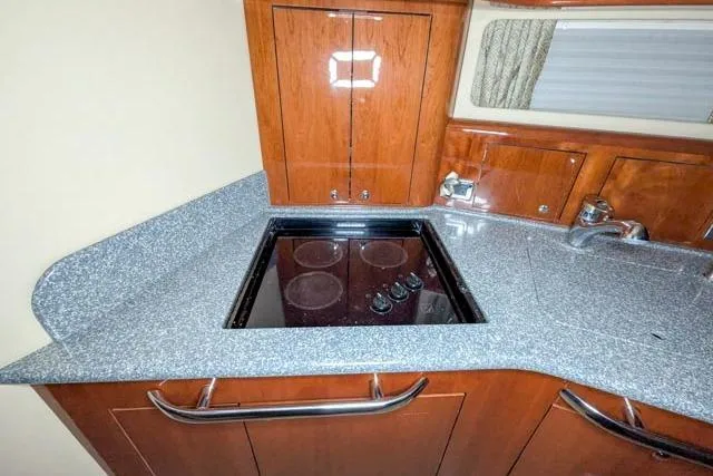 Tigress Yacht Photos Pics Luxurious 2002 Sea Ray 550 Sundancer yacht kitchen with sleek countertops and modern appliances.