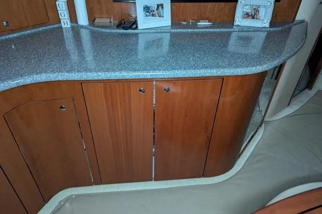 Tigress Yacht Photos Pics 2002 Sea Ray 550 Sundancer interior with wooden cabinets and granite countertop.