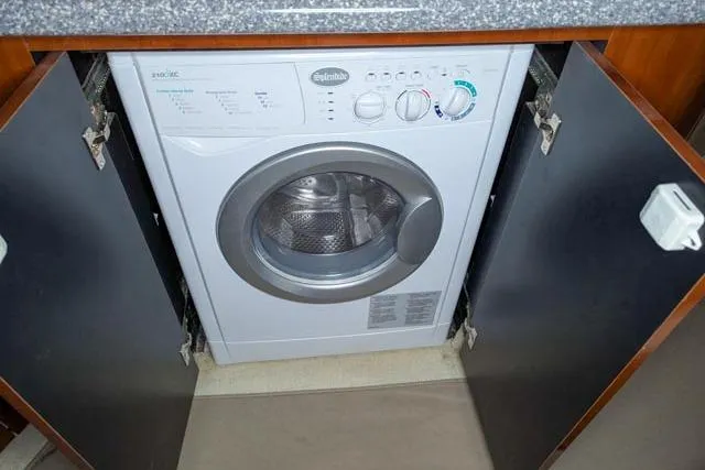 Tigress Yacht Photos Pics Washing machine inside a 2002 Sea Ray 550 Sundancer yacht's cabinet.