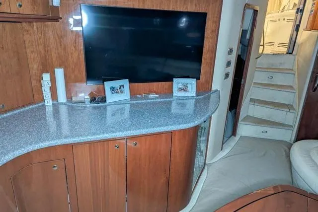 Tigress Yacht Photos Pics Interior of 2002 Sea Ray 550 Sundancer yacht with TV, cabinets, and stairs.