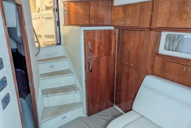 Tigress Yacht Photos Pics Interior of 2002 Sea Ray 550 Sundancer yacht with wooden cabinetry and white seating.