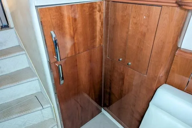 Tigress Yacht Photos Pics 2002 Sea Ray 550 Sundancer interior with wooden cabinetry and stairs.