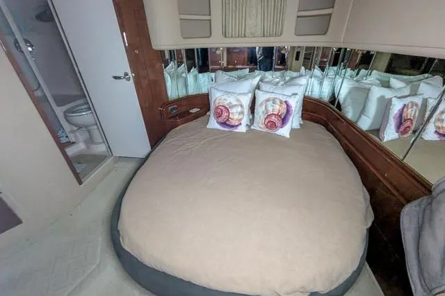 Tigress Yacht Photos Pics Luxurious bedroom interior of 2002 Sea Ray 550 Sundancer yacht with mirrored walls.