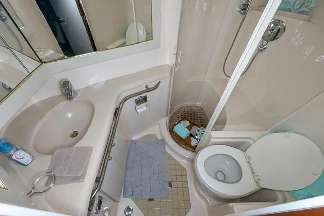 Tigress Yacht Photos Pics Bathroom interior of 2002 Sea Ray 550 Sundancer yacht, featuring sink, toilet, and shower.