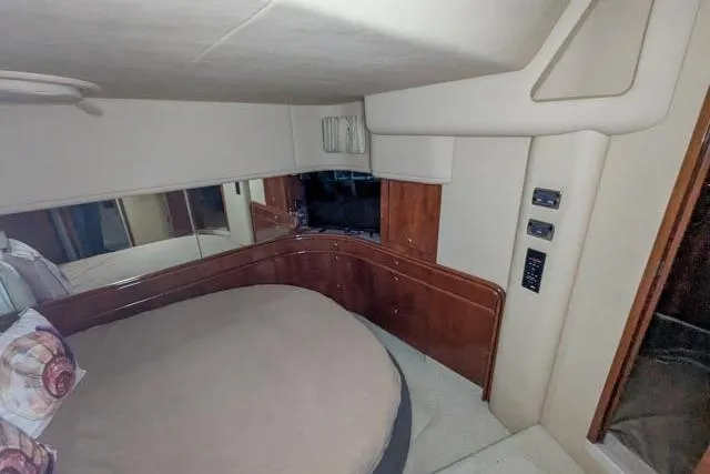 Tigress Yacht Photos Pics Interior cabin of 2002 Sea Ray 550 Sundancer yacht with bed and wood paneling.