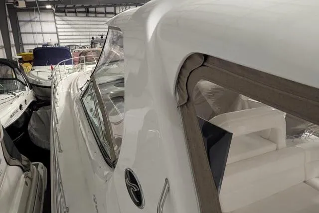 Tigress Yacht Photos Pics 2002 Sea Ray 550 Sundancer yacht in indoor storage, showcasing sleek design and luxury features.