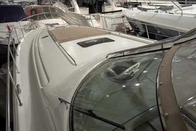 Tigress Yacht Photos Pics 2002 Sea Ray 550 Sundancer yacht in marina, showcasing sleek design and spacious deck.