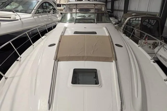Tigress Yacht Photos Pics 2002 Sea Ray 550 Sundancer yacht, docked indoors, showcasing sleek design and spacious deck.