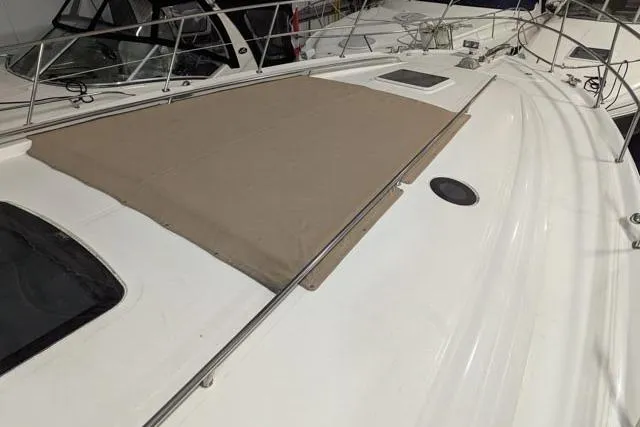 Tigress Yacht Photos Pics 2002 Sea Ray 550 Sundancer yacht deck with beige cover and railing.