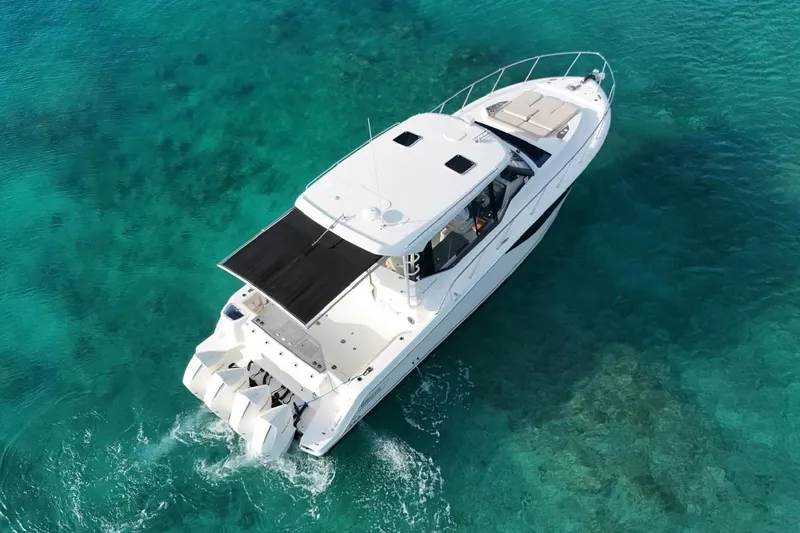  Yacht Photos Pics 2022 Boston Whaler 405 Conquest cruising on clear turquoise waters.