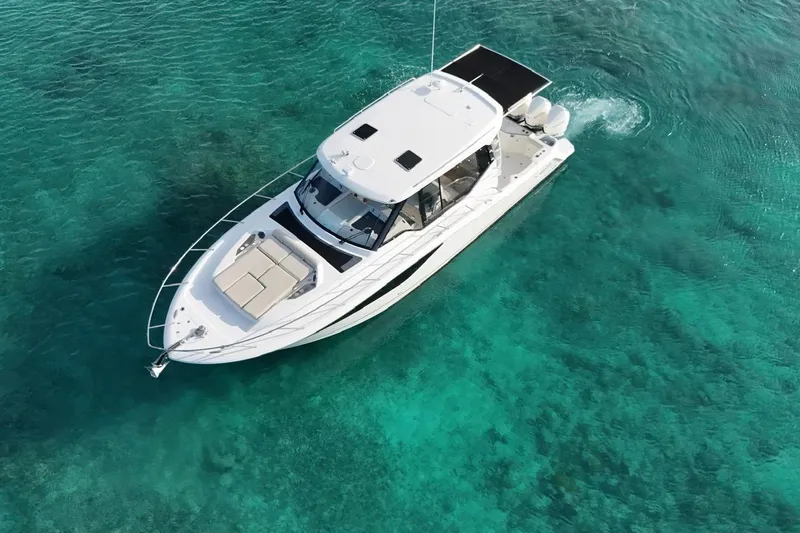  Yacht Photos Pics Boston Whaler 405 Conquest 2022 cruising on clear turquoise waters.