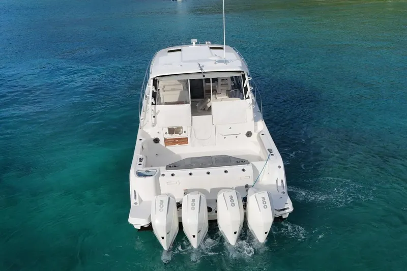  Yacht Photos Pics 2022 Boston Whaler 405 Conquest boat on clear blue water, rear view.