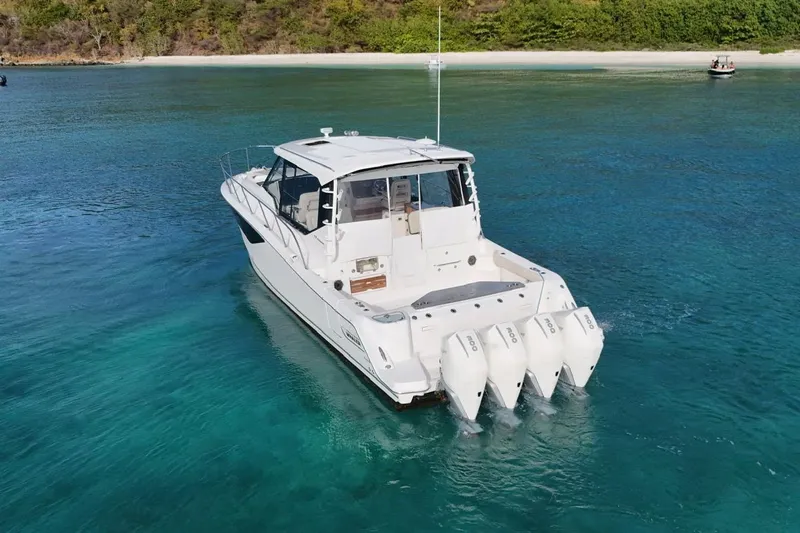  Yacht Photos Pics 2022 Boston Whaler 405 Conquest boat cruising in clear turquoise waters.