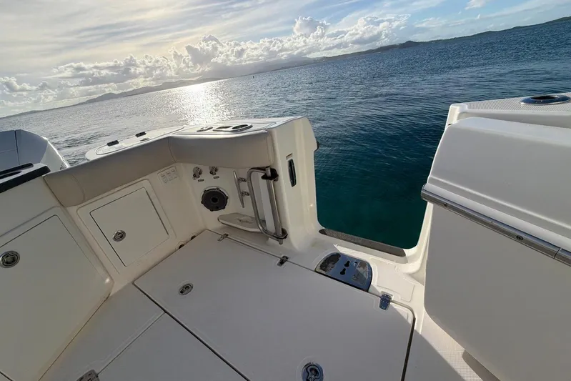  Yacht Photos Pics 2022 Boston Whaler 405 Conquest boat deck with ocean view at sunset.