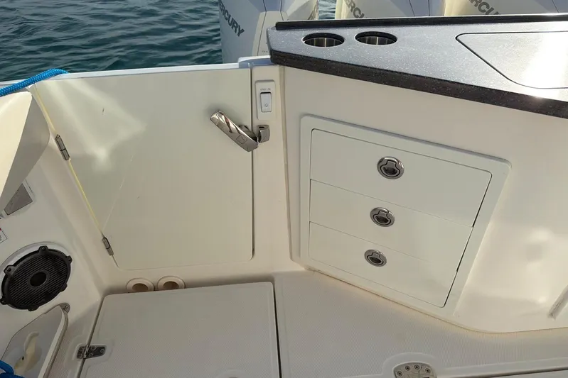  Yacht Photos Pics Interior view of 2022 Boston Whaler 405 Conquest boat with storage compartments and cup holders.