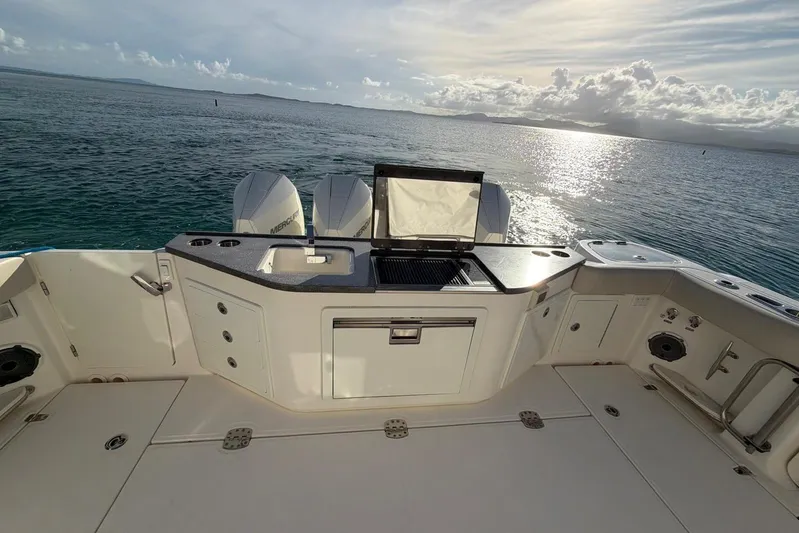  Yacht Photos Pics 2022 Boston Whaler 405 Conquest boat deck with grill and ocean view.