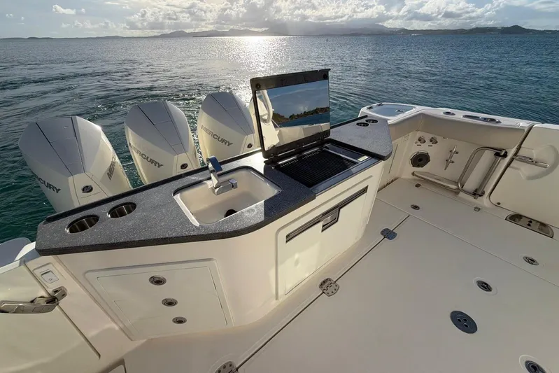  Yacht Photos Pics Boston Whaler 405 Conquest 2022 boat deck with sink and grill, ocean view.