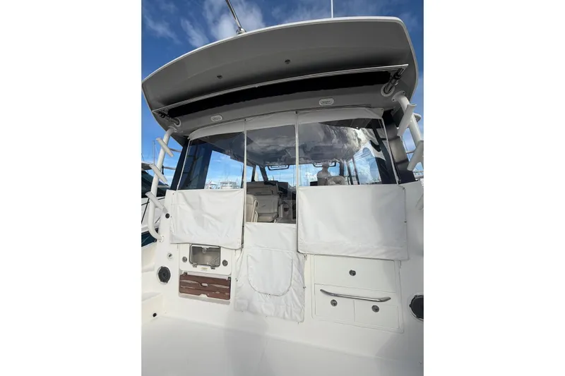 Yacht Photos Pics 2022 Boston Whaler 405 Conquest boat interior with covered seating and storage.
