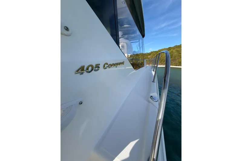  Yacht Photos Pics 2022 Boston Whaler 405 Conquest boat side view with railing and ocean backdrop.
