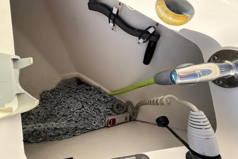  Yacht Photos Pics Anchor chain storage on 2022 Boston Whaler 405 Conquest boat, featuring coiled rope and equipment.