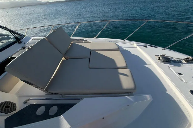  Yacht Photos Pics Luxury sunbed on 2022 Boston Whaler 405 Conquest yacht, overlooking serene ocean waters.