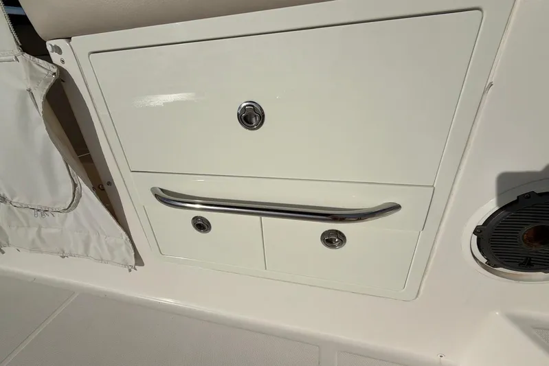  Yacht Photos Pics 2022 Boston Whaler 405 Conquest storage compartment with chrome handle and lock.