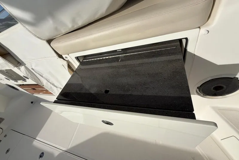  Yacht Photos Pics 2022 Boston Whaler 405 Conquest interior with sleek black countertop and seating.