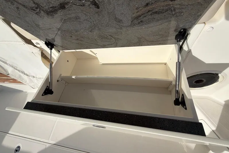  Yacht Photos Pics Open storage compartment on 2022 Boston Whaler 405 Conquest boat, featuring hydraulic supports.