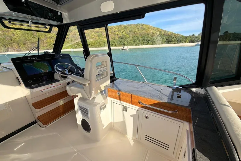  Yacht Photos Pics Interior view of 2022 Boston Whaler 405 Conquest boat with scenic water backdrop.