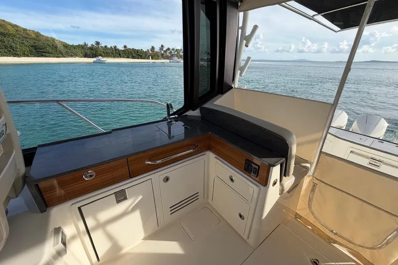  Yacht Photos Pics Interior view of 2022 Boston Whaler 405 Conquest yacht with sleek cabinetry and ocean backdrop.