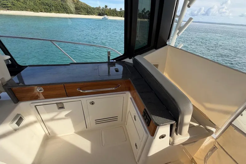  Yacht Photos Pics Boston Whaler 405 Conquest 2022 interior with seating and cabinetry, overlooking ocean view.