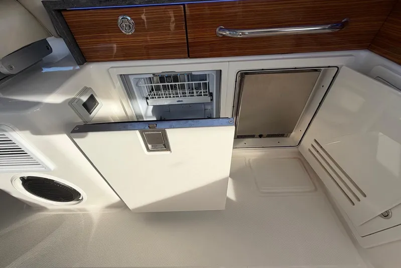  Yacht Photos Pics 2022 Boston Whaler 405 Conquest interior with open fridge and storage compartments.