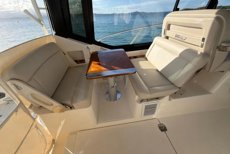  Yacht Photos Pics 2022 Boston Whaler 405 Conquest interior seating with table, overlooking ocean view.