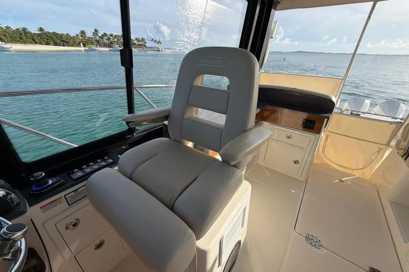  Yacht Photos Pics Captain's chair on 2022 Boston Whaler 405 Conquest, overlooking serene ocean view.