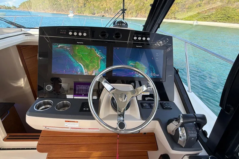  Yacht Photos Pics 2022 Boston Whaler 405 Conquest helm with dual navigation screens and steering wheel.
