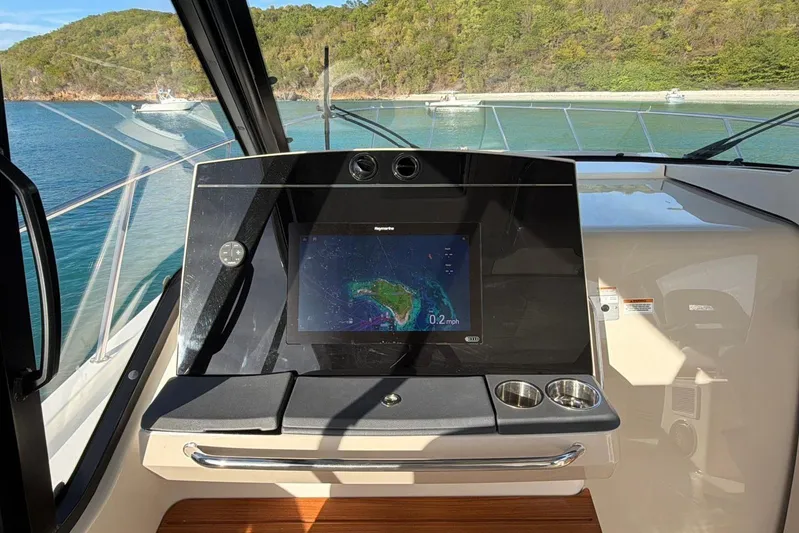  Yacht Photos Pics Helm of 2022 Boston Whaler 405 Conquest with navigation display, overlooking scenic bay.