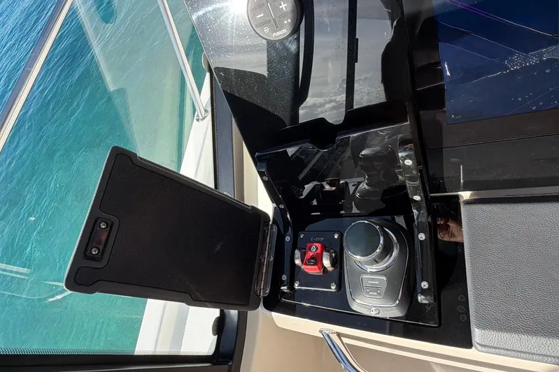  Yacht Photos Pics Control panel of 2022 Boston Whaler 405 Conquest boat with joystick and emergency stop button.