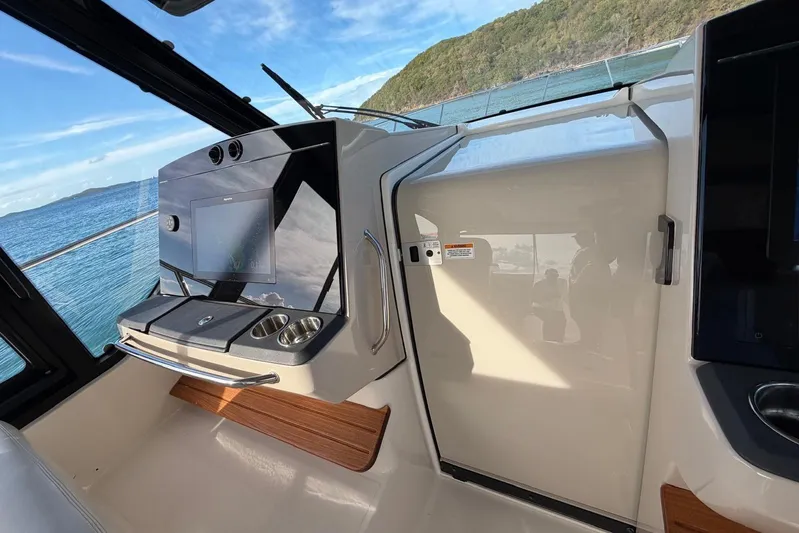  Yacht Photos Pics Interior view of 2022 Boston Whaler 405 Conquest boat cockpit with ocean backdrop.