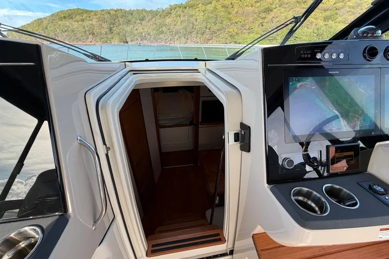  Yacht Photos Pics Interior view of 2022 Boston Whaler 405 Conquest with navigation display and cabin entrance.