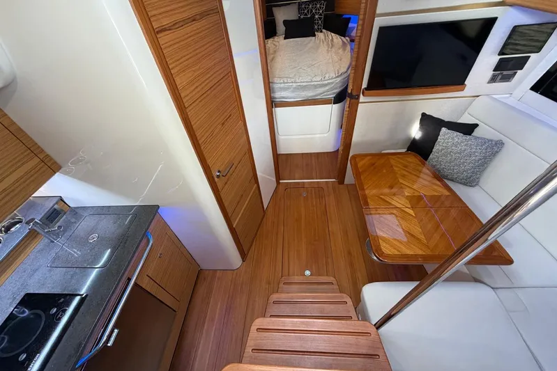  Yacht Photos Pics Interior of 2022 Boston Whaler 405 Conquest, featuring modern kitchen and cozy seating area.
