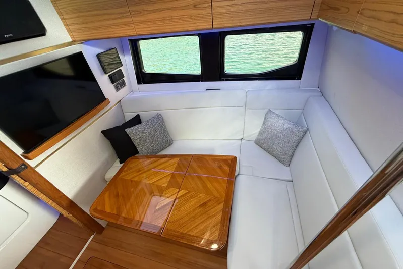  Yacht Photos Pics Luxurious interior of 2022 Boston Whaler 405 Conquest with elegant seating and wooden table.