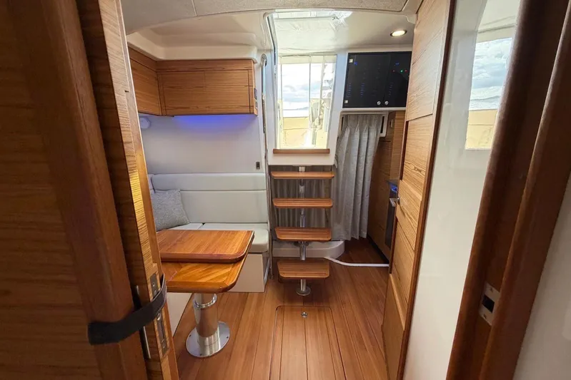  Yacht Photos Pics Interior of 2022 Boston Whaler 405 Conquest, featuring wooden finishes and modern design.