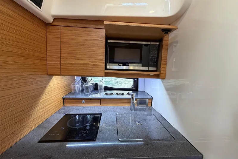  Yacht Photos Pics Modern kitchen in 2022 Boston Whaler 405 Conquest with microwave and induction cooktop.