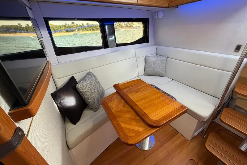  Yacht Photos Pics Luxurious interior of 2022 Boston Whaler 405 Conquest with elegant seating and wooden table.