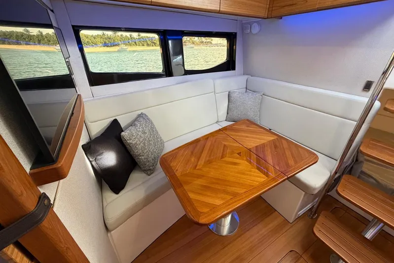  Yacht Photos Pics Luxurious interior of 2022 Boston Whaler 405 Conquest with elegant seating and wooden table.
