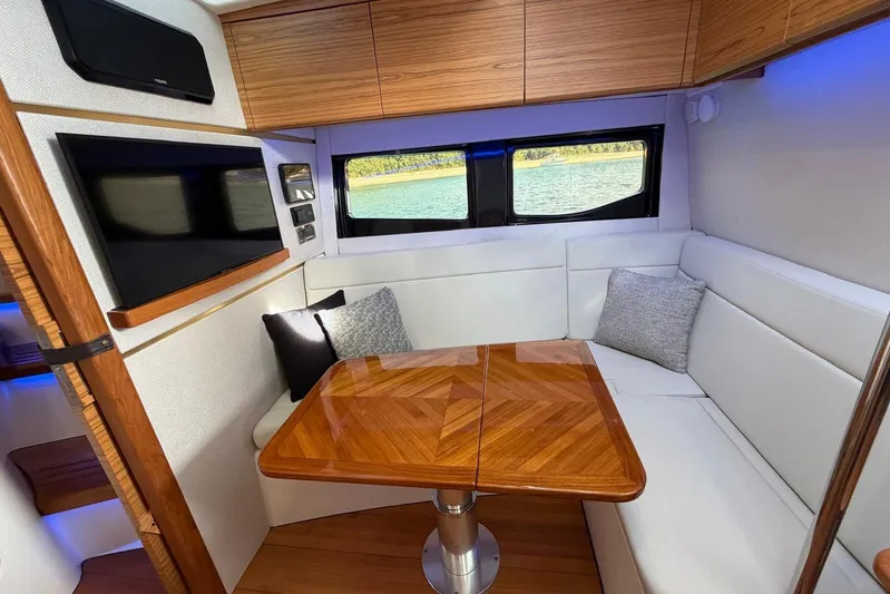  Yacht Photos Pics Luxurious interior of 2022 Boston Whaler 405 Conquest with elegant wood table and seating.